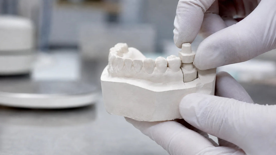 Dental technician checking the stability of a removable die in a stone dental model